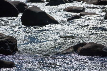 Silhouette rocks in flowing river, Nan Province, Thailandの写真素材