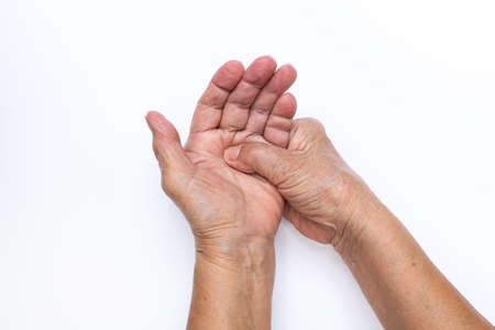 Senior woman's hand doing herself massage isolated on white background, About massage conceptの写真素材