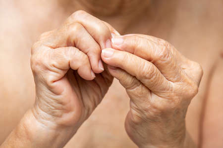Senior woman nibbling nails, Close up, Body language feelingの写真素材