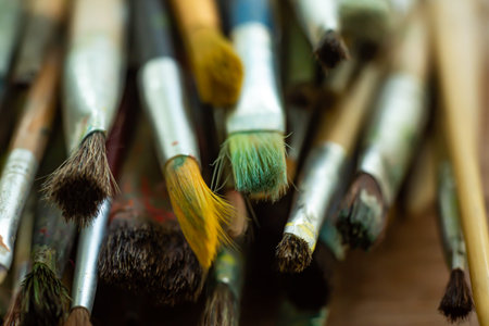 Old, Dirty Paint Brushes on wood table ground, Close up & Macro shot, Selective focus, Stationery conceptの写真素材