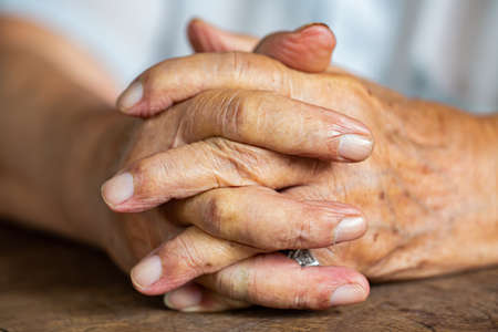 Senior man's holding his hands and praying, Close up & Macro shot, Selective focus, Asian Body skin part, Body language feeling, Religious conceptの写真素材