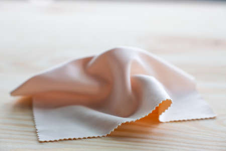 Microfibre cleaning cloths for eyeglasses on wooden background, Close up & Macro shot, Selective focus, Optical conceptの写真素材