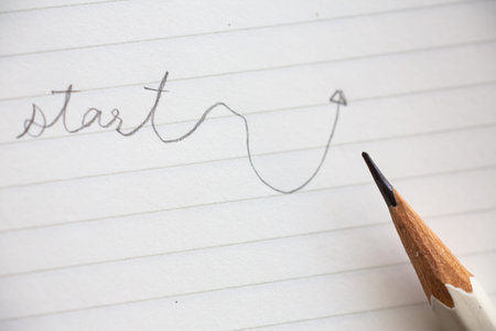 Hand writing " Start " on white paper background, Close up & Macro shot, Selective focus, Stationery conceptの写真素材
