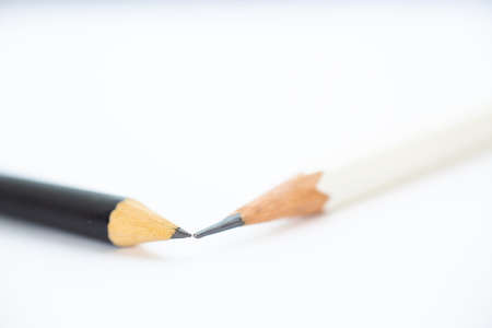 A white pencil with a black pencil on white background, Close up & Macro shot, Selective focus, Stationery conceptの写真素材