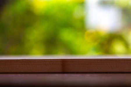 Empty wooden table texture, Green garden blurred bokeh background, Selective focus