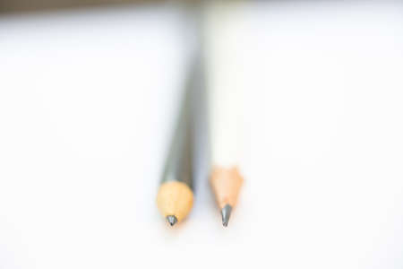 A white pencil with a black pencil on white background, Close up & Macro shot, Selective focus, Stationery conceptの写真素材