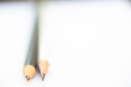 A white pencil with a black pencil on white background, Close up & Macro shot, Selective focus, Stationery conceptの写真素材