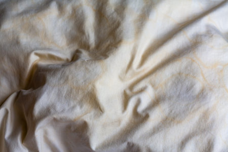Dirty stained pillow on new white bed, Close up and macro shot, Selective focus, Bedroom cleaning conceptの写真素材
