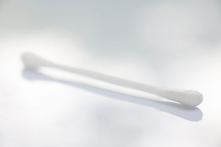 One white plastic cotton buds on white table texture background, Close up & Macro shot, Selective...