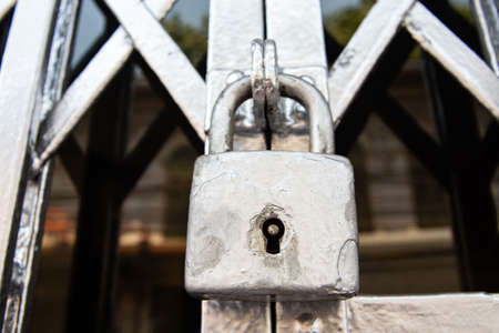 Closed silver steel door stretch with locked key, Close up & Macro shot, Selective focusの写真素材