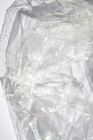 Abstract crumpled transparent plastic bag texture on white background, Close up & Macro shot, Selective focus, Light & Shadow, Recycle conceptの写真素材