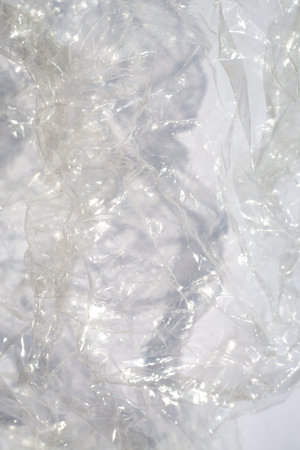 Abstract crumpled transparent plastic bag texture on white background, Close up & Macro shot,...