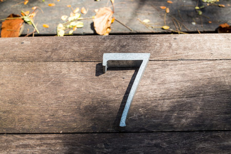 Number 7 (seven) made  from galvanized iron on wood texture backgroundの写真素材