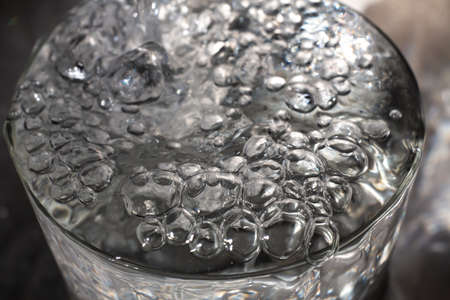 Clear water bubbles floating in transparent glass, Close up & Macro shot, Selective focus, Healthy Drink conceptの写真素材