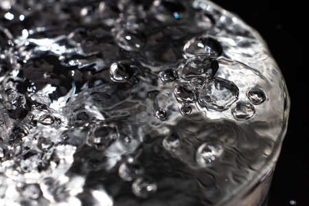 Clear water bubbles floating in transparent glass, Close up & Macro shot, Selective focus, Healthy Drink conceptの写真素材