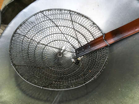 Stainless steel colander with handle wood on aluminium trayの写真素材