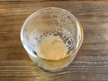 Empty coffee cup after drink on wood background, Close up shot