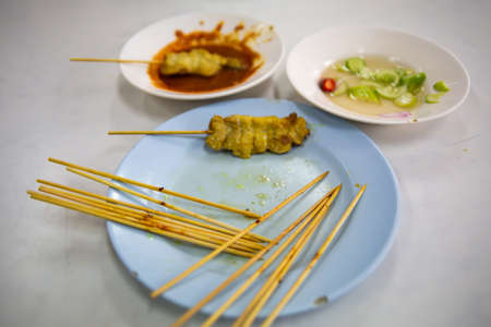 Skewer and Pork Satay with your Peanut Sauce and pickles which are cucumber slices and onions in vinegar,  Close up & Macro shot, Selective focusの写真素材
