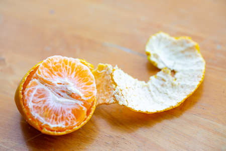 Orange fruit slice and  peeled on wooden table background, Close up shot, Selective focusの写真素材