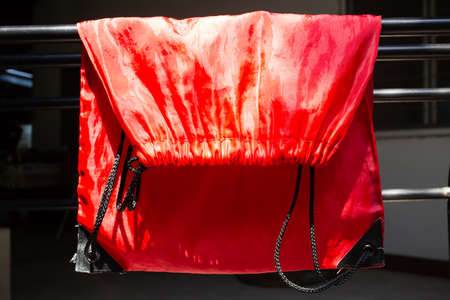 Dry Polyester Tote Bag in the sun, Red glossy texture backgroud, Close up & macro shot, Sport  bag conceptの写真素材