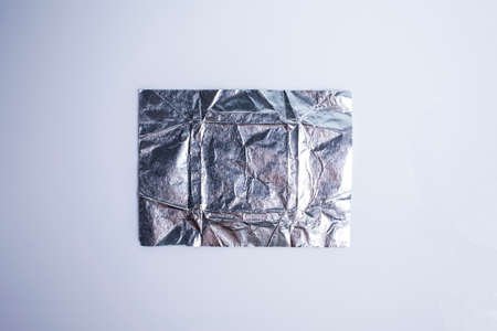 Wrinkled aluminium foil Paper isolated on white backgroundの写真素材