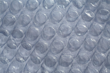 Blurred Plastic Bubble Cushioning Wrap surface texture on white background, Light & Shadow concept