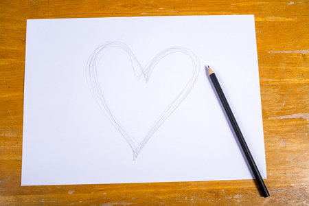 Heart drawn by pencil on paper sheet, Valentine's day conceptの写真素材