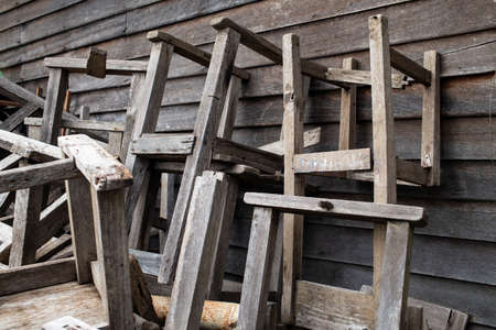 Broken vintage wooden chairs and vintage wooden desks in old schoolの写真素材
