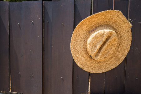 Straw hat on wood background