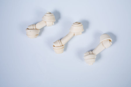 Three dog bones isolated on white backgroundの写真素材