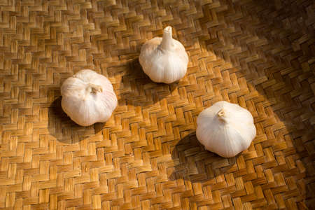 Garlic on rattan basket background, Garlic on wicker basket background, Top viewの写真素材