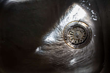 Water flowing and splashing in sink, Light and shadow, Close up & Macro shot, Selective focus, Healthcare conceptの写真素材