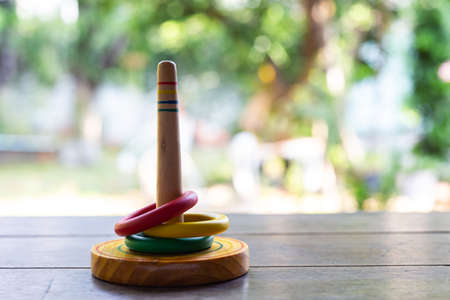 Quoits, wooden toy on wooden texture in bokeh garden background, Selective focus, Close up shot, Game and Recreation for children conceptの写真素材