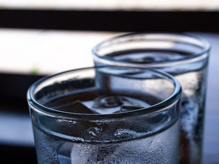 Two cold water glass with ice cubes, Water drops, Close up & Macro shot, Selective focus, Healthy Drink conceptの写真素材