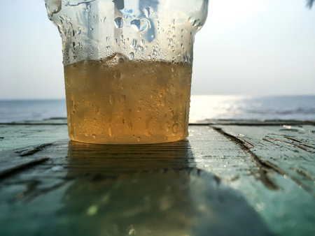 Cold water with ice cubes in plastic glass, Water drops, Close up & Macro shot, Selective focus, Healthy Drink conceptの写真素材