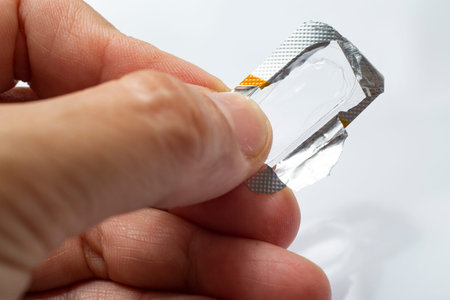 Woman's hand holding package without capsule on white background,Close up & Macro shot, Selective...
