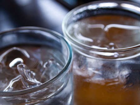 Two cold water glass with ice cubes, Water drops, Close up & Macro shot, Selective focus, Healthy Drink conceptの写真素材
