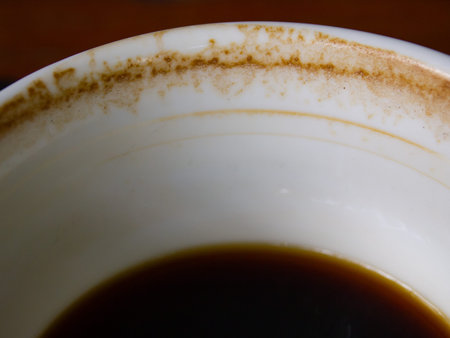 Coffee cup stained, americano coffee drink left over on wooden table background, Close up and macro shot, Selective focusの写真素材