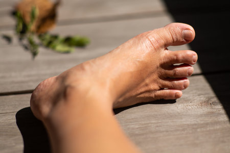 Women's second toes, middle toe, fourth toe crooked, In wooden background, Close up & Macro shot,...