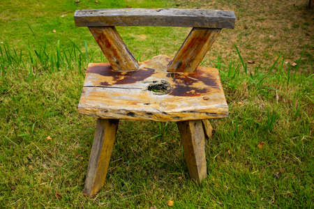 Handmade wooden chair on the grass texture backgroundの写真素材