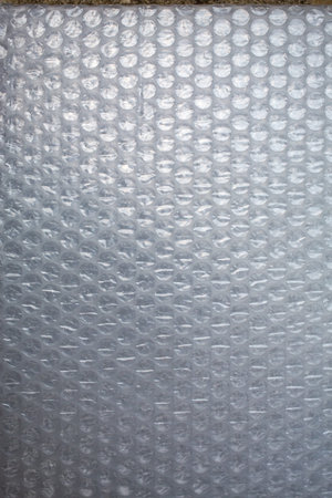 Plastic Bubble Cushioning Wrap surface texture on white background, Close up shot, Transparent...