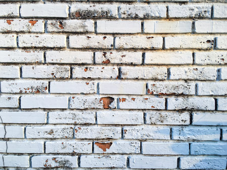 Grunge white colour striped bricks or Peeled white colour concrete wall texture background, Interior...