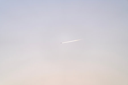 Airplane in the sky at sunset, background with copy space.