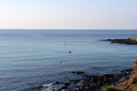tranquil seascape at the rocky seaside in Jeju Island, South Koreaの写真素材