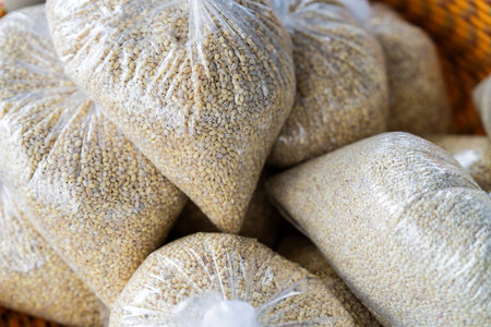various grains in plastic bags on the market. Close up.の写真素材