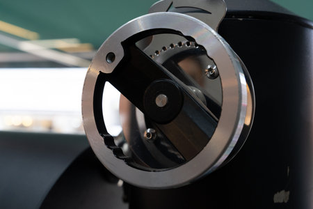 Close-up of a stainless steel coffee grinder at a coffee shop
