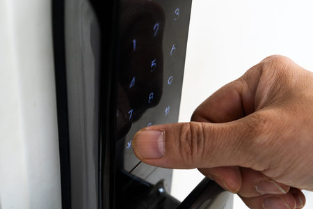 Close-up of a hand pressing the button on a house door lock