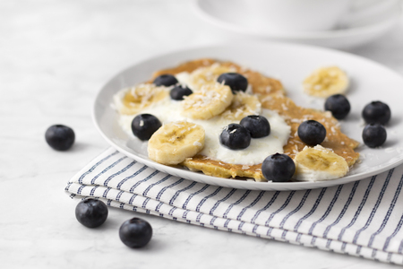 Healthy pancakes with fresh berry, fruits and yogurt. Summer breakfast concept. Delicious traditional morning foodの写真素材
