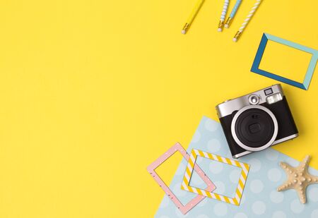 Flat lay travel accessories on yellow background with space for text.の写真素材