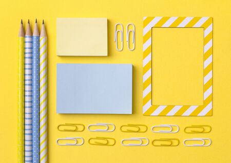 School office supplies at yellow background with copy space. Flat lay back to school concept.の写真素材